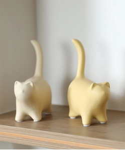 Detail view of ceramic cat figurines with smooth minimalist lines and anti-slip pads