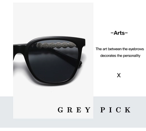 Detail of square black sunglasses with silver wavy metal texture on the frame