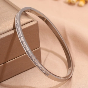 Detail of silver titanium steel bracelet featuring rectangular clear crystal pavé setting