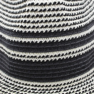 Close-up detail of the premium black and white striped woven straw hat texture