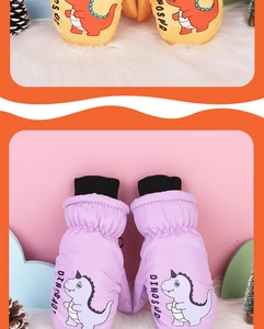 Detail of insulated waterproof kids ski mittens with cute cartoon dinosaur prints