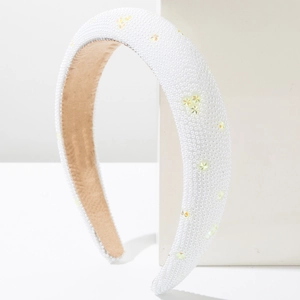 Elegant wide sponge headband with white pearls and iridescent star accents on a clean display