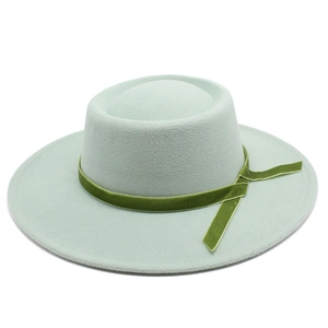 Close-up of mint green wool felt hat featuring an olive green velvet decorative ribbon