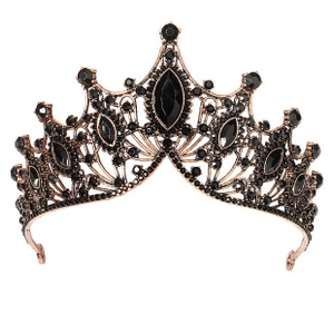 Detailed close-up of vintage baroque crown with black rhinestones and bronze metal frame