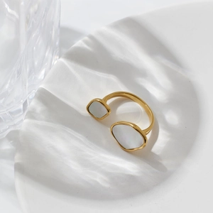 Minimalist gold open ring with iridescent white shell inlay on a white background
