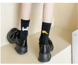 Detail view of cotton crew socks with colorful specks and cute cartoon character designs