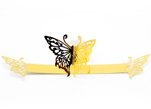 Detail of laser-cut gold butterfly napkin ring showing metallic texture and craftsmanship