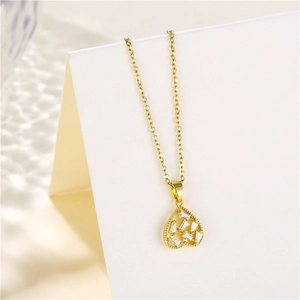 Close-up of golden heart pendant necklace with shimmering zircon stones in high detail