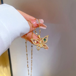 Detailed macro view of butterfly pendant with colorful zircons and gold plating