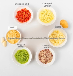 Manual grinder results showing finely chopped garlic, ginger, and peppers in white bowls