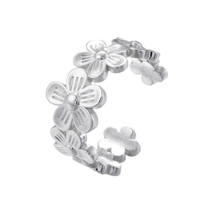 Detailed view of silver flower petals on adjustable ring band with polished finish