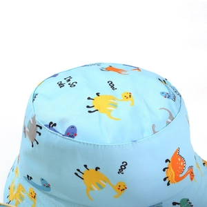 Detail of light blue bucket hat fabric showing cute dinosaur prints and fine twill texture