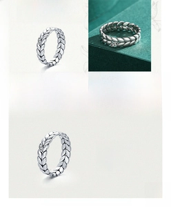 Detail of 925 sterling silver ring with textured leaf design and small zircon accents