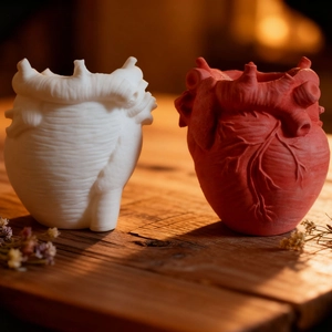 Detailed view of anatomical heart resin vases with realistic vessel textures on wood