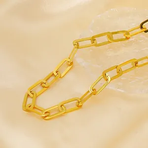 Elegant 18K gold plated stainless steel paperclip chain necklace on silk background