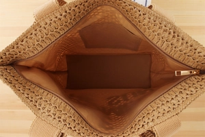 Top view of large woven tote bag showing spacious interior with zipper closure and brown lining