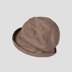 Detailed texture of dark brown linen bucket hat with retro multi-panel stitching