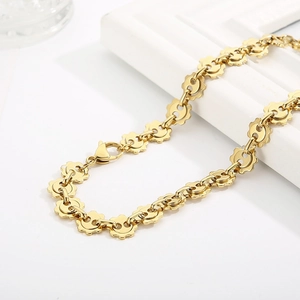 Gold stainless steel gear link necklace displayed on white background with soft shadows