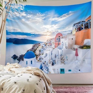 Detail of Santorini wall tapestry featuring blue domes and Aegean sunset in bedroom