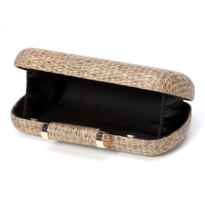 Detail view of woven evening clutch with black interior lining and gold metal hardware