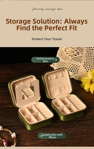 Internal layout of green velvet jewelry box showing mirror and necklace hooks