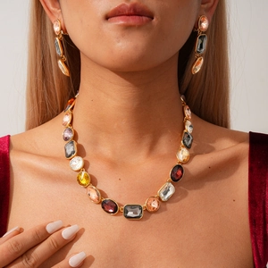 Vintage geometric jewelry set with colorful crystals and gold necklace on female model