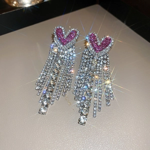 Sparkling pink rhinestone heart fringe tassel earrings with shimmering starburst light effect