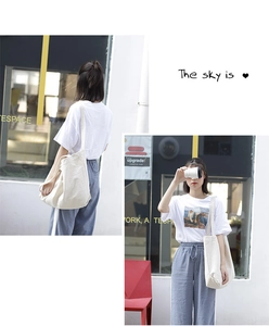 Asian model wearing a minimalist large capacity white canvas tote bag for casual daily use