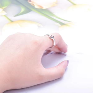 Adjustable silver crescent moon ring for women worn elegantly against yellow tulips