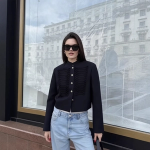 Chic black slim-fit cropped jacket with fringe detail and silver buttons street style