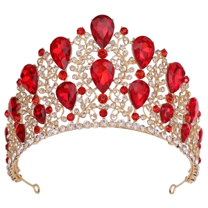 Close-up of golden Baroque crown featuring pear-cut red crystals and clear rhinestones