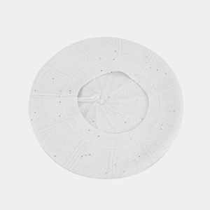 Top view of a white knitted beret with sparkling silver sequins and soft texture