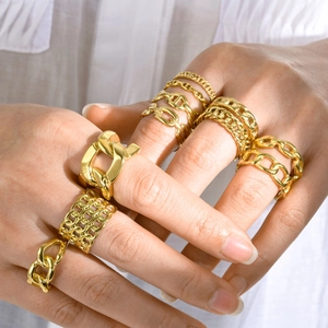 Detailed view of layered 18k gold plated chain rings with varied link textures and patterns