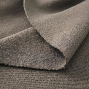 Macro detail of high-quality knit texture in dark coffee brown for asymmetrical shawl