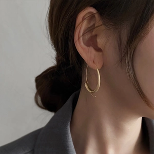 Minimalist matte gold hoop earrings with smooth large circle design for a chic look
