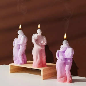 Close-up of romantic couple candle set in gradient pink and purple tones with soft lighting