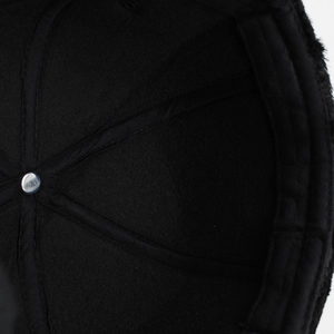 Close-up of winter hat interior with warm fleece lining and reinforced cross stitching