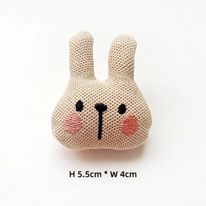 Detail of handmade crocheted rabbit charm showing 5.5cm height and 4cm width measurements