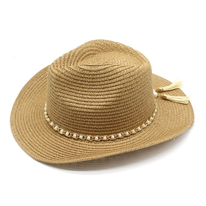 French vintage straw sun hat with pearl chain trim and tassels on white background