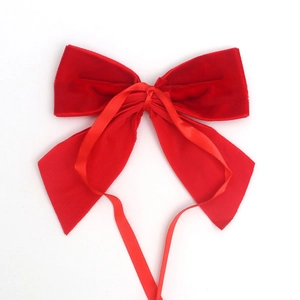 Classic red velvet bow hair accessory with long ribbons on a white background