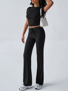 Detail view of black short sleeve crop top and drawstring flared trousers set