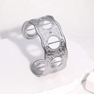 Silver wide cuff bracelet with hammered texture and hollow rings in stainless steel