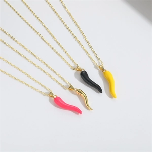 Detailed view of colorful chili pepper pendants in pink, gold, black and yellow on gold chains