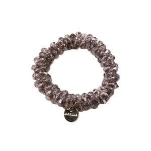 Elegant champagne beaded hair tie and bracelet dual-use accessory with gold logo tag