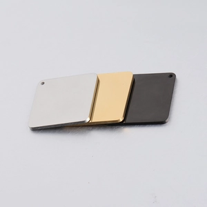 Close-up of rectangle mirror finish steel tags in silver, gold and black with hole