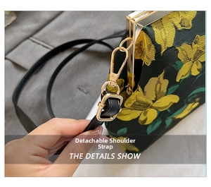 Detail showing the detachable leather shoulder strap and golden metal lobster clasp