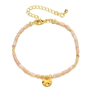 Detail of natural stone beaded bracelet with golden hammered coin charm and lobster clasp
