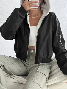 Elegant black hooded bomber jacket with white fleece lining and utility sleeve pocket