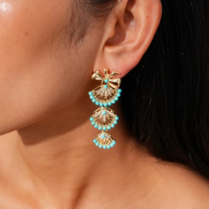 Close-up of fan-shaped bow earrings with sky blue beads and sparkling crystals