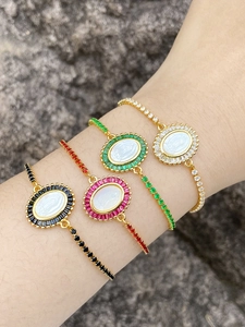 Detailed view of Virgin Mary bracelets with colorful zircon stones on woman wrist